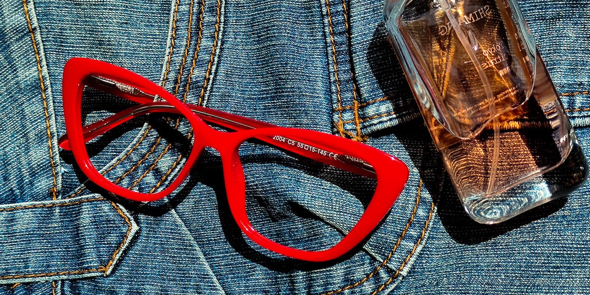cat eye glasses with red frame by a perfume