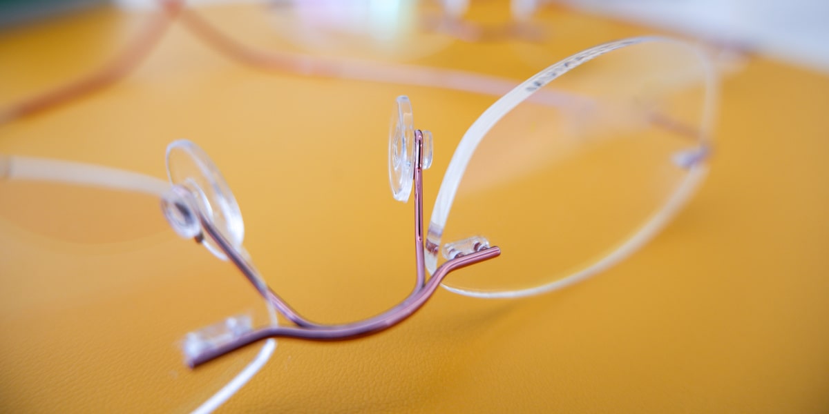 rimless glasses with pink frame