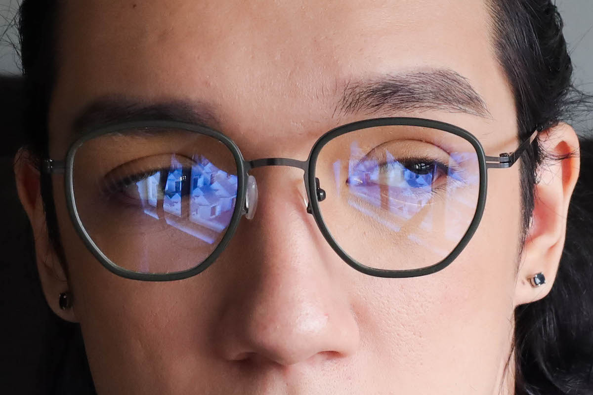 man wearing blue light glasses