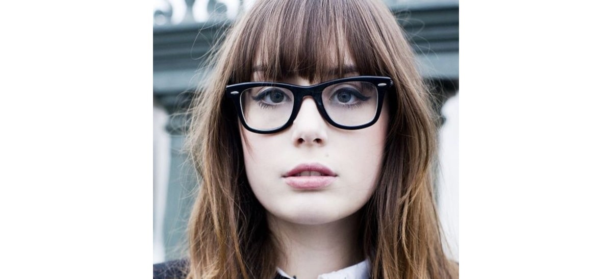 woman with blunt bangs wearing d frame glasses