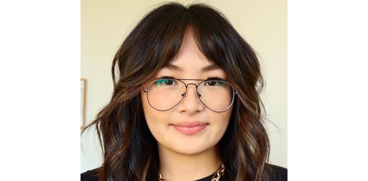 woman with curtain bangs wearing aviator frames