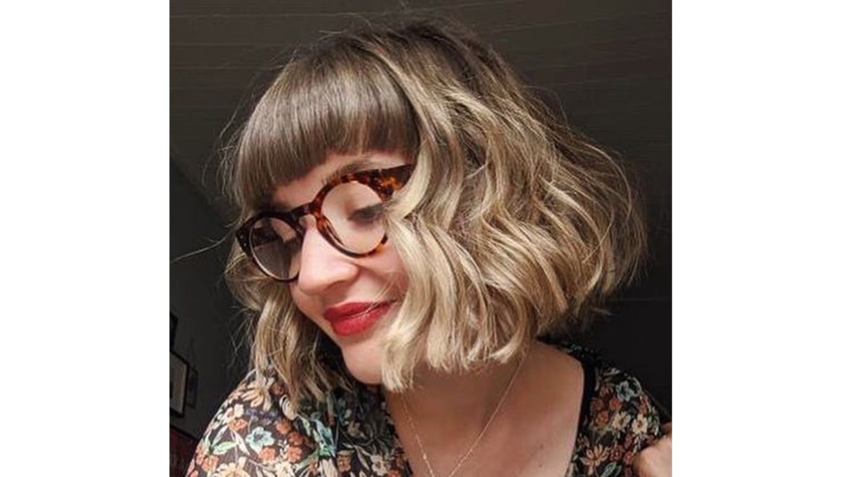 woman with micro bangs wearing tortoise shell glasses