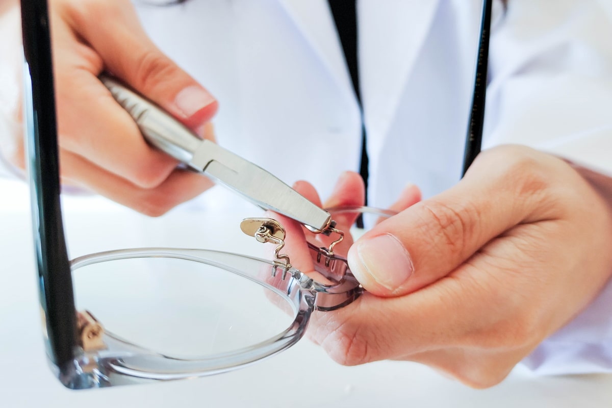 mouqy optician adjusting nosepad of a frame