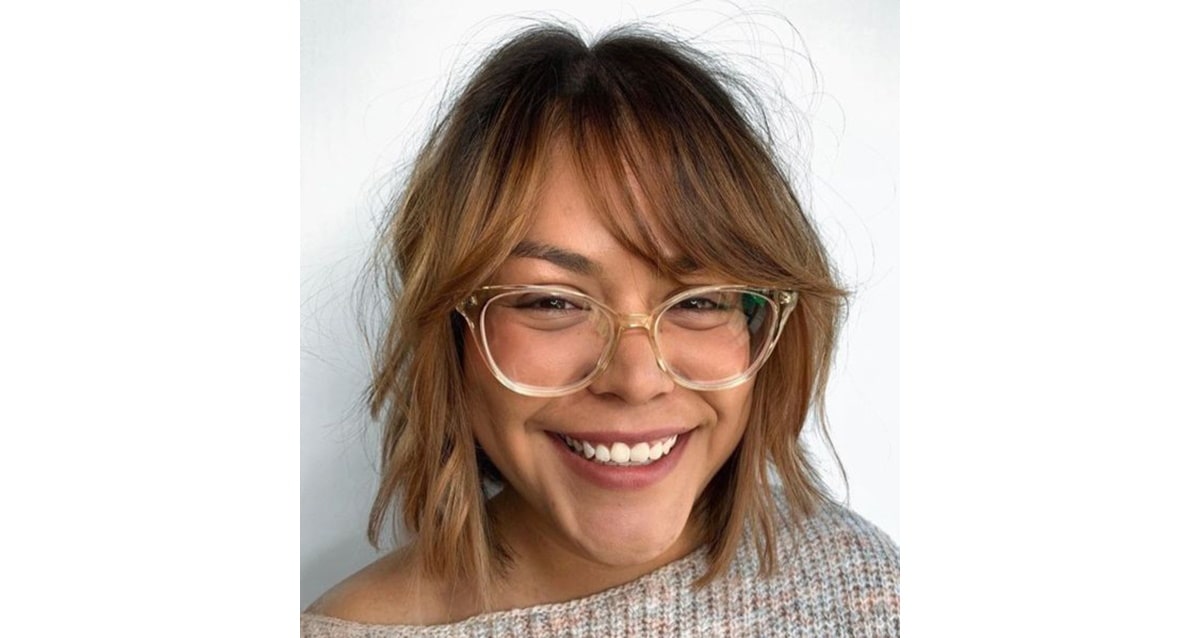 woman with side swept bangs wearing cat eye glasses
