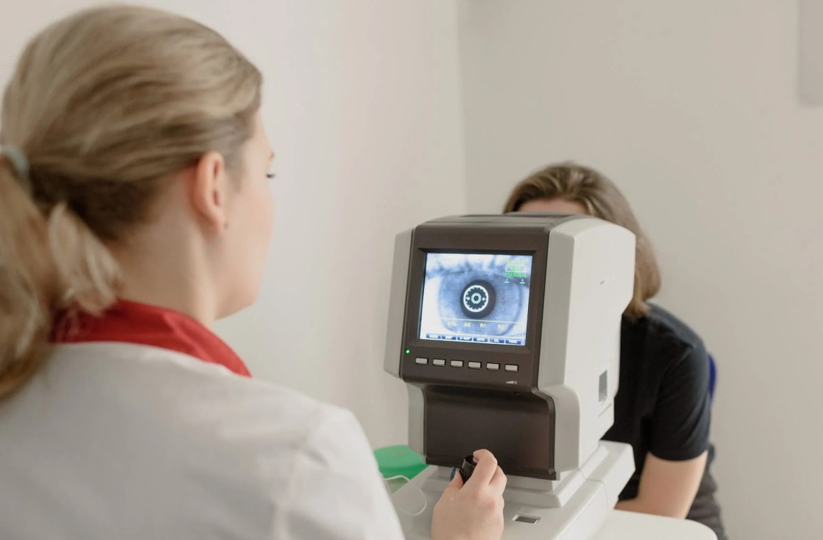 an optician conducting an eye exam to a patient