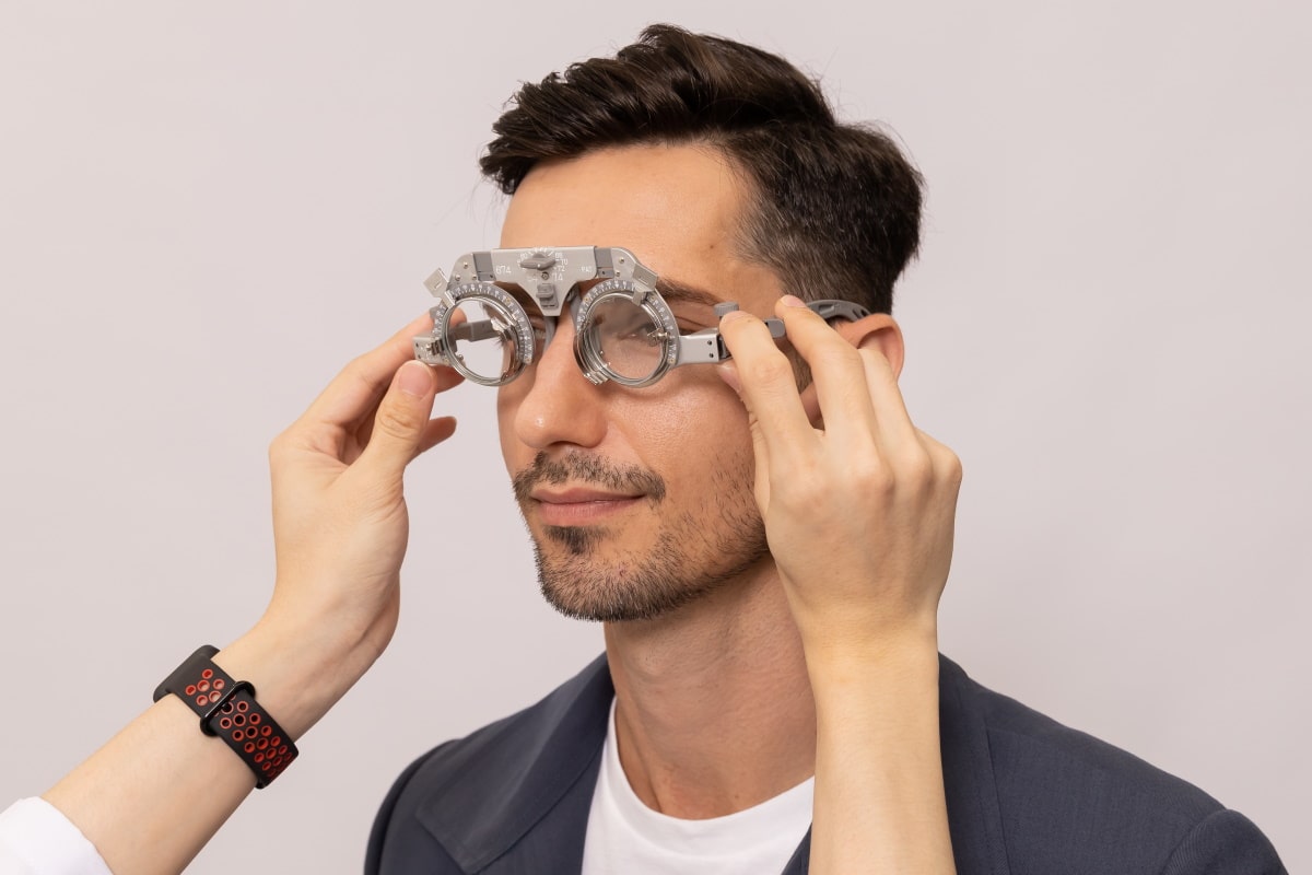 man getting eye check with trial frame