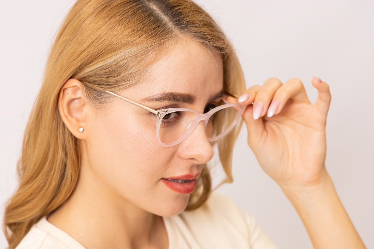 woman testing out a pair of glasses frame