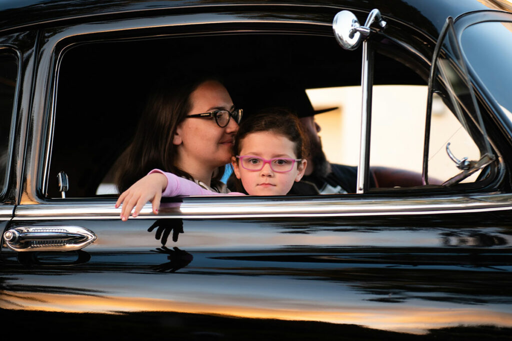 mother and little girl wearing eyeglasses in a car