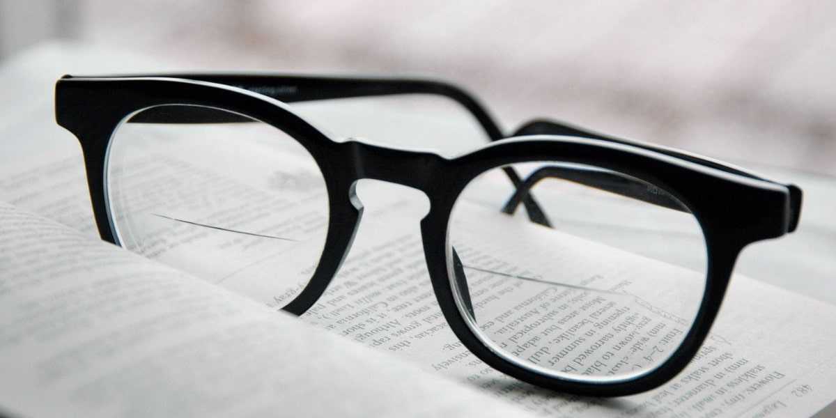 a pair of bifocal glasses with black oval frame