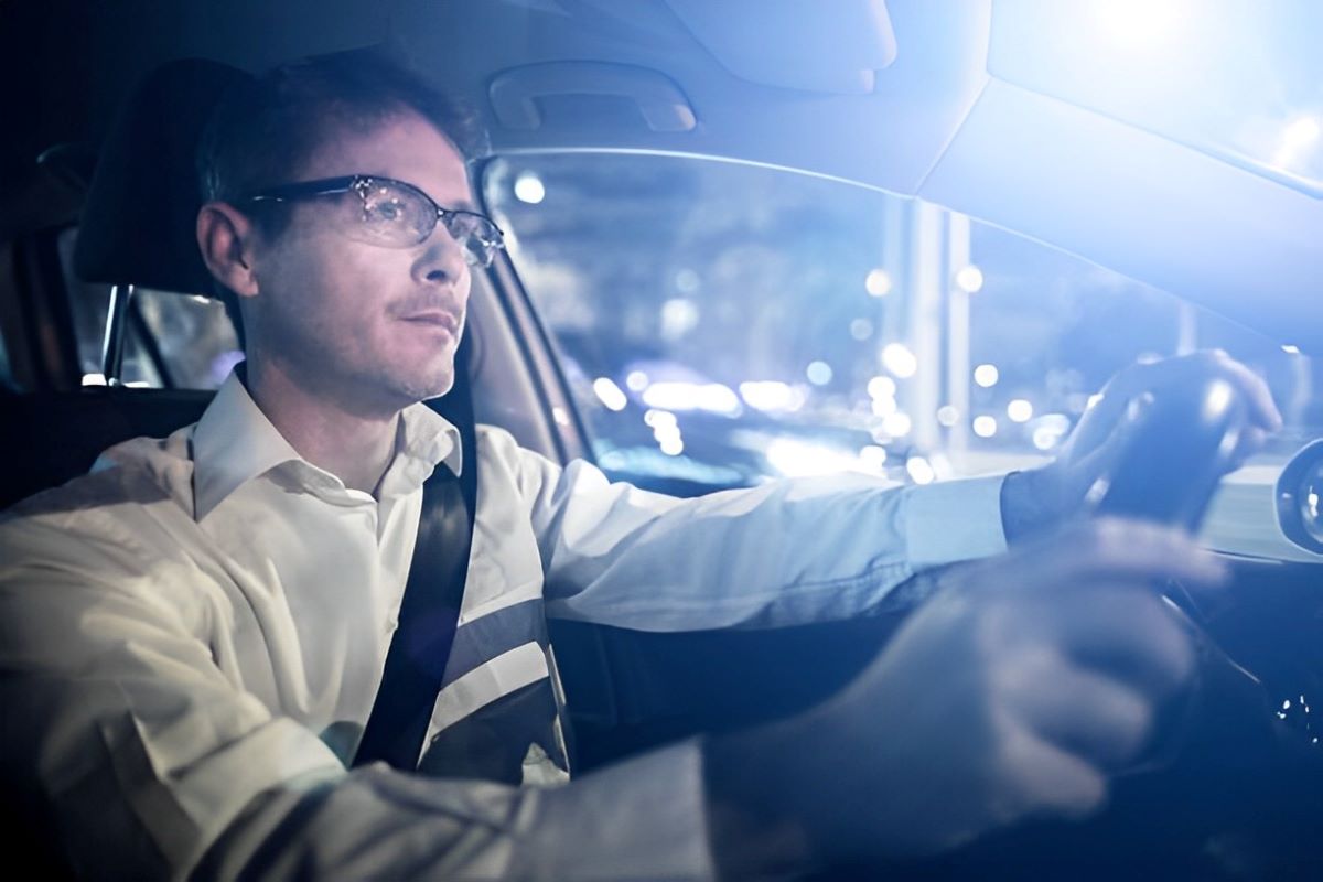 man driving while wearing glasses with polished lens