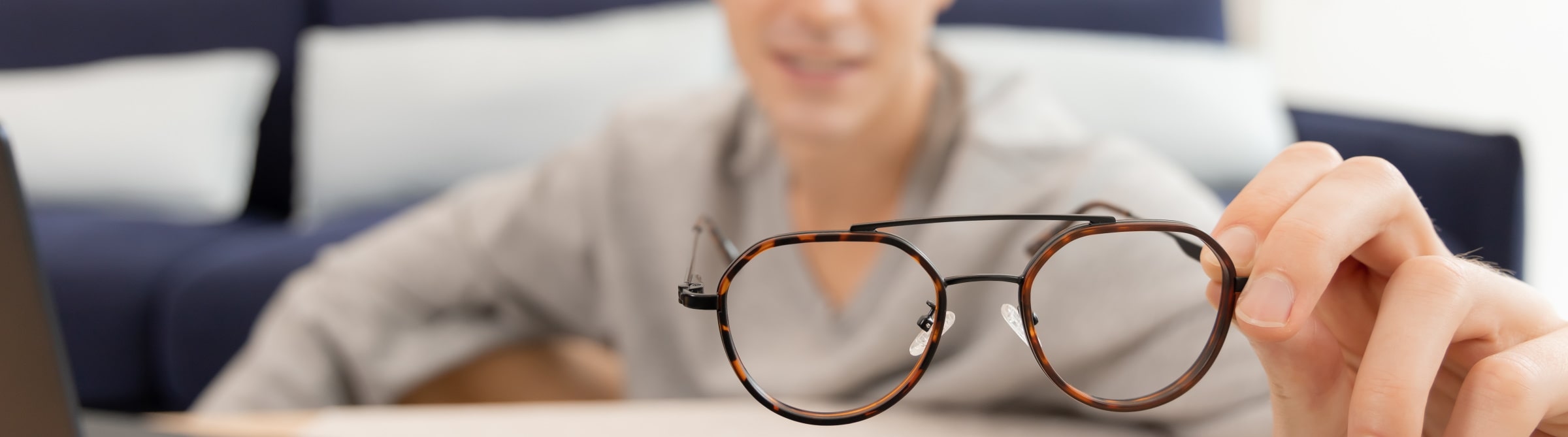 a man holding a pair of glasses frame and getting measurements