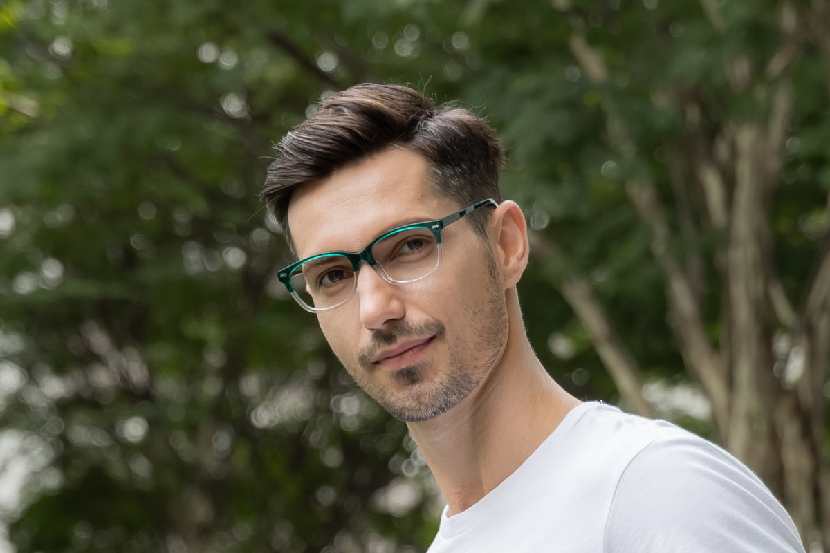 man wearing prescription glasses with tribrid lenses in the outdoors