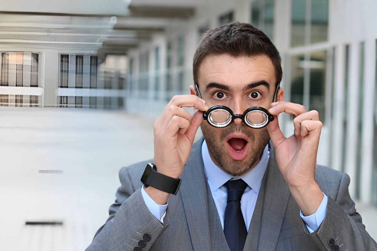 man wearing a pair of round glasses for strong prescription with thick lenses