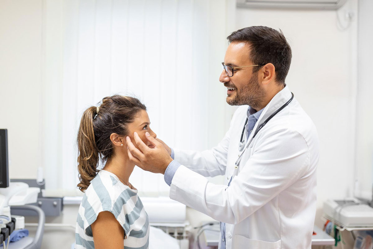 optometrists gives initial check-up on a patient for her eye health