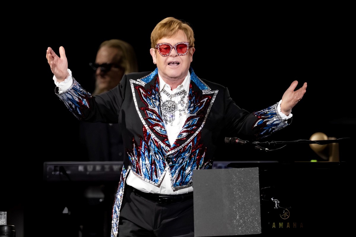 elton john in red tinted glasses