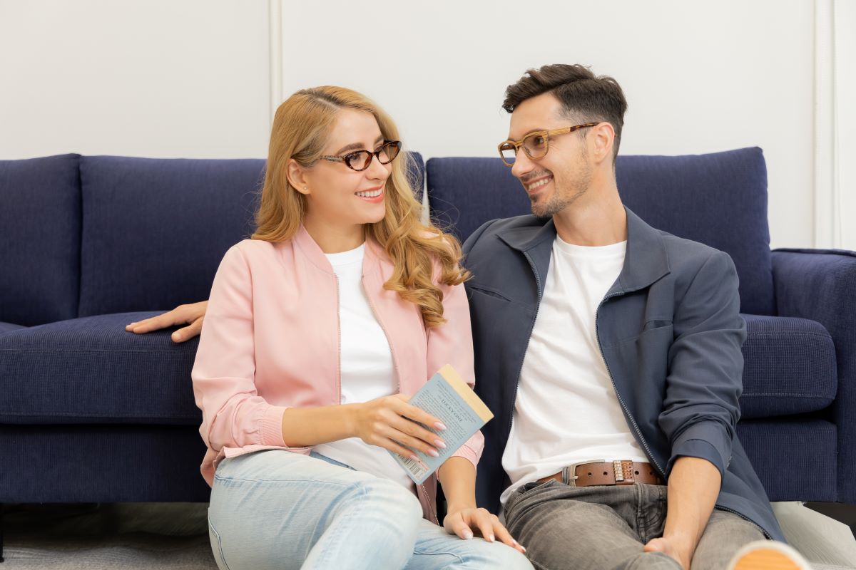 happy couple with glasses on smiling widely