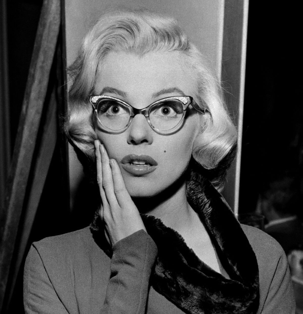marilyn monroe as pola debevoise with a pair of glasses for the libarian look