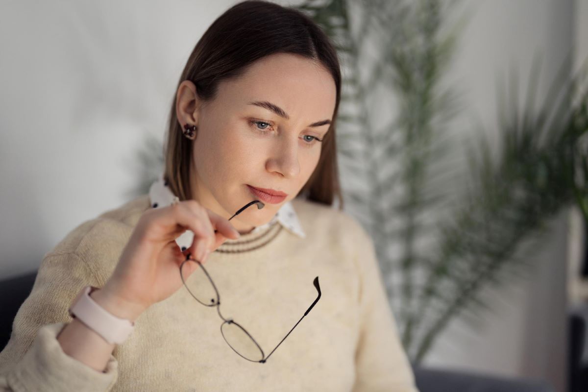 thoughtful woman with glasses