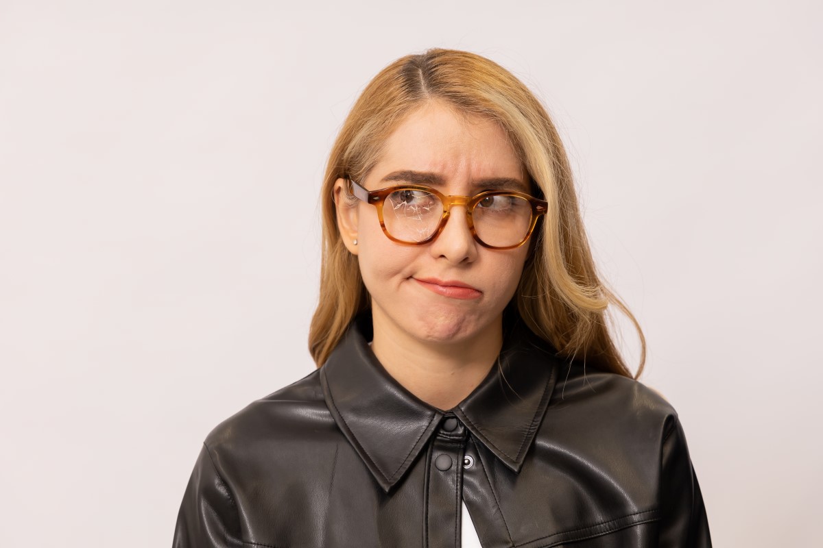 unhappy woman wearing glasses with cracked lens