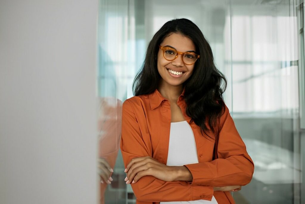 woman-smiling-widely with bright colored frame glasses