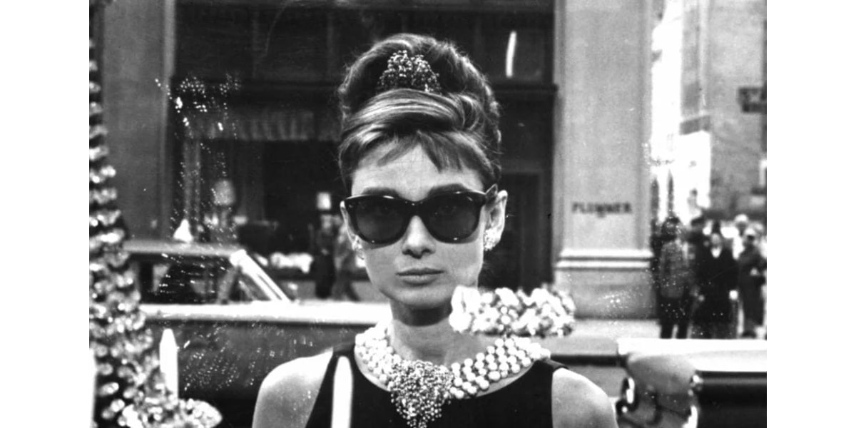 Audrey Hepburn wearing a pair of sunglasses for breakfast at tiffany