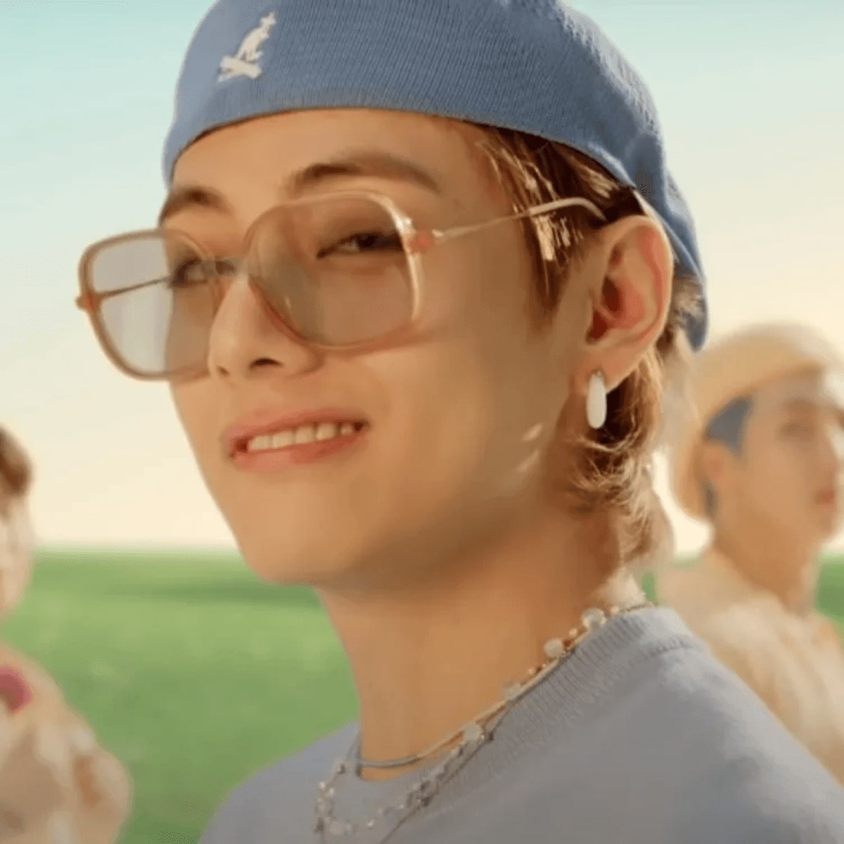 V from BTS wearing a pair of sunglasses in the dynamite music video