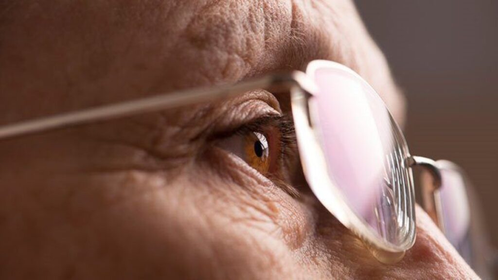 old person wearing a pair of glasses for age related farsightedness