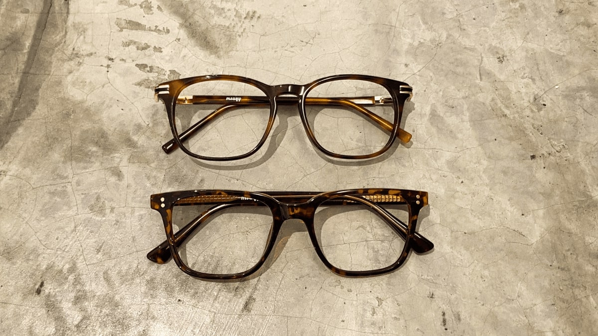 two pairs of similar looking glasses frame flatlay