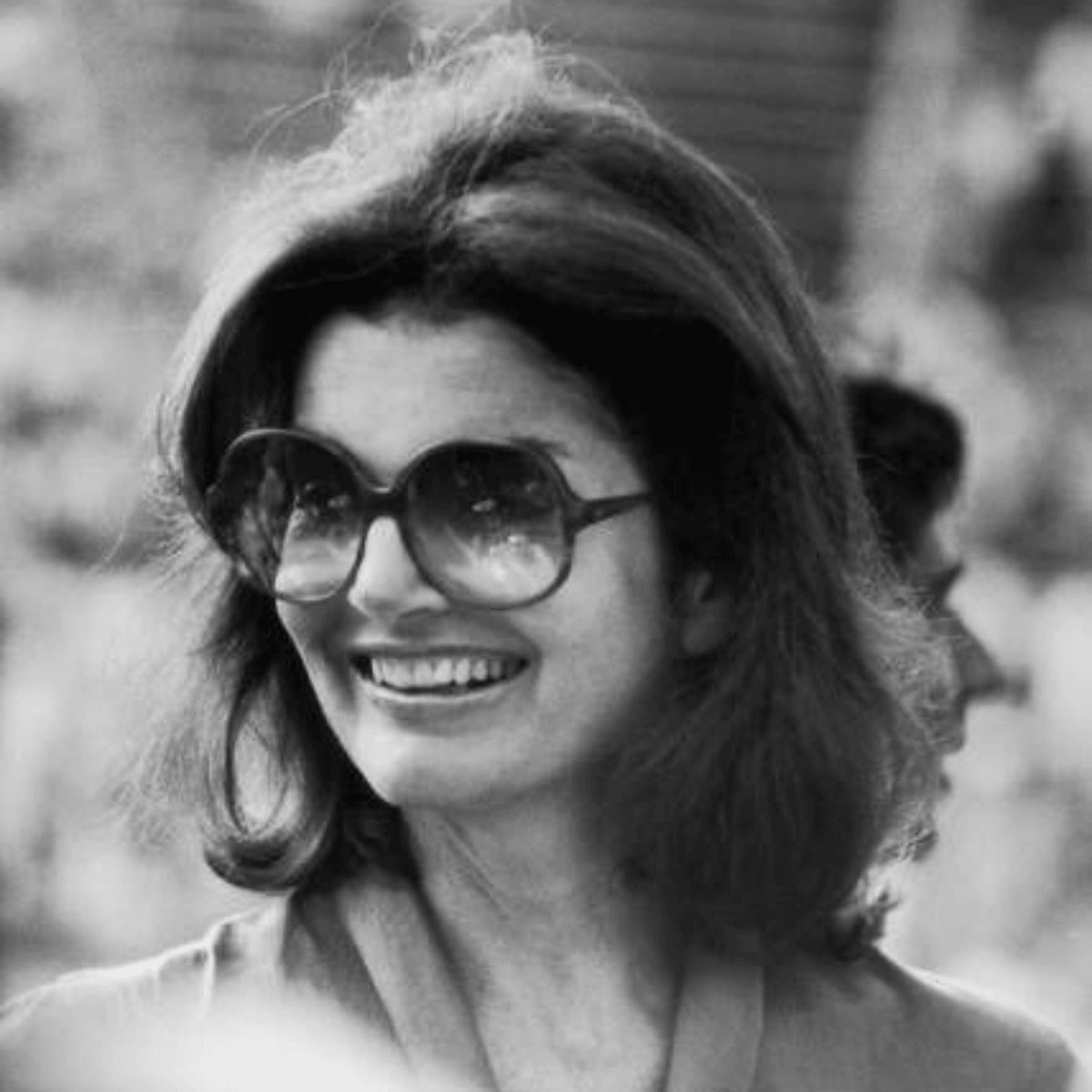 jackie o in sunglasses during a tennis tournament