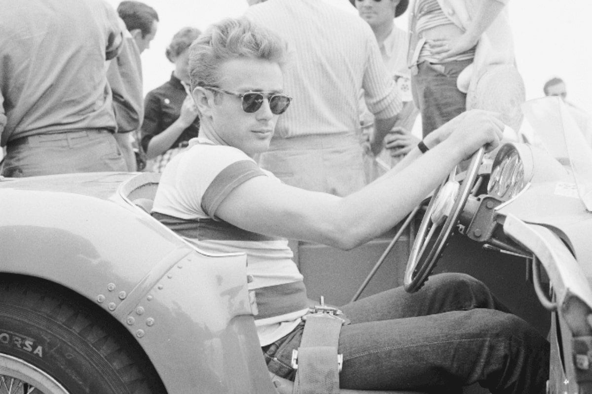 james dean wearing a pair of sunglasses in a ferrari