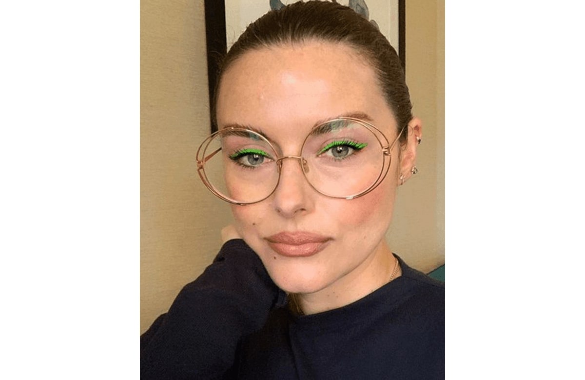 katie jane hughes wearing a pair of glasses with green eyeliner