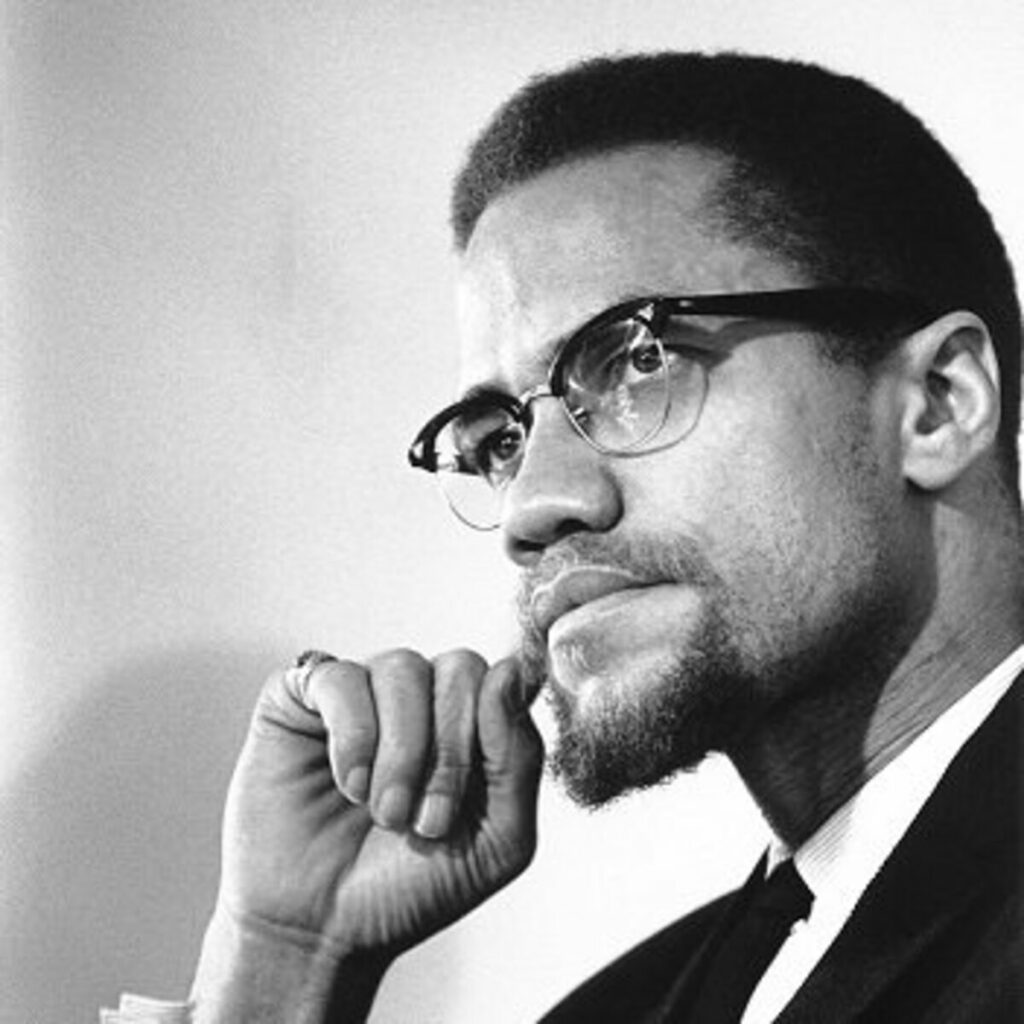 malcolm x wearing his famous browline glasses