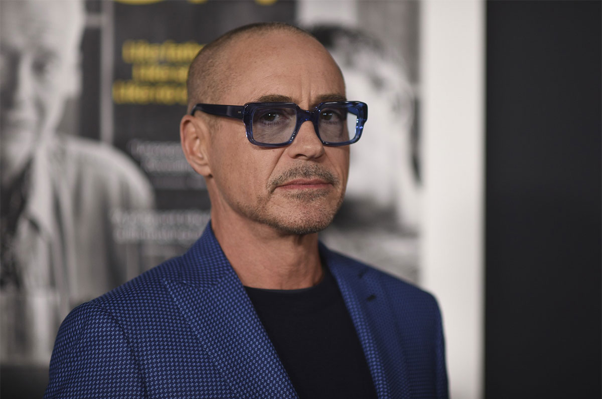 bald robert downey jr with a pair of blue glasses