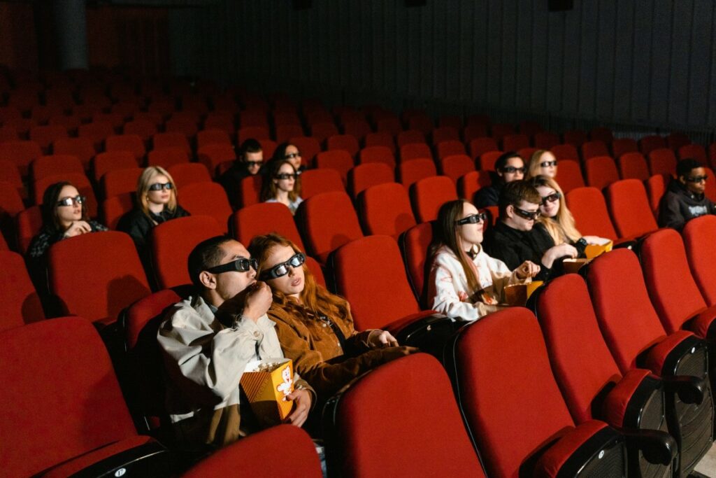 movie goers wearing 3d glasses while watching movie