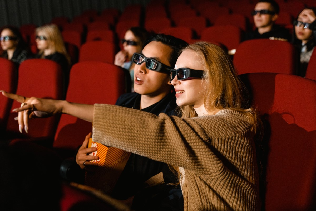 movie goers wearing active shutter glasses while watching 3d movie