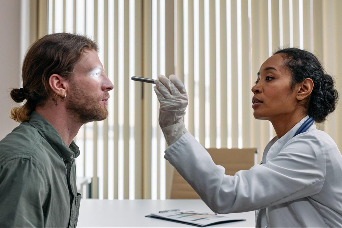 eye doctor conducting an air puff test to a male patient