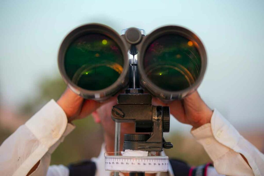 a person looking through a binocular