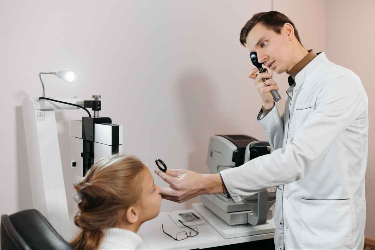 an eye doctor diagnosing for binocular vision problems on a patient