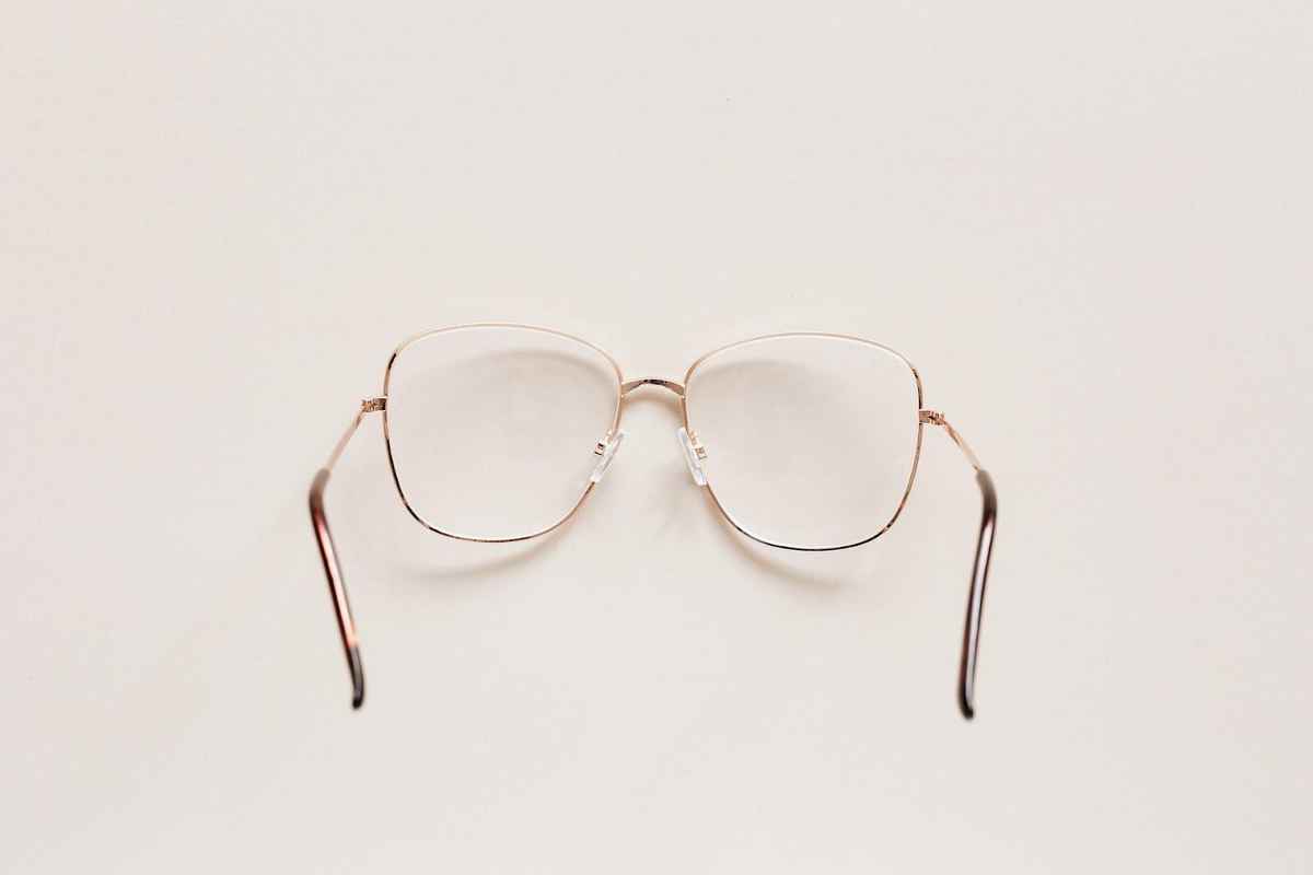a pair of thin glasses frame placed with lens side down