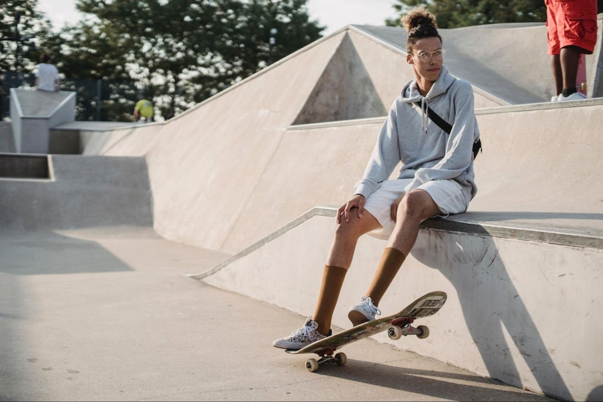 a man with skateboard wearing a pair of glasses