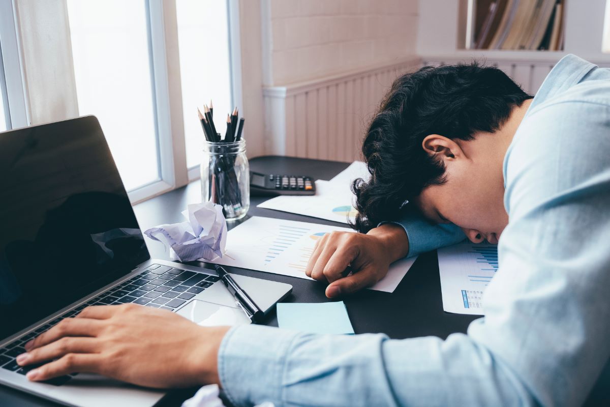 man sleeping at desk