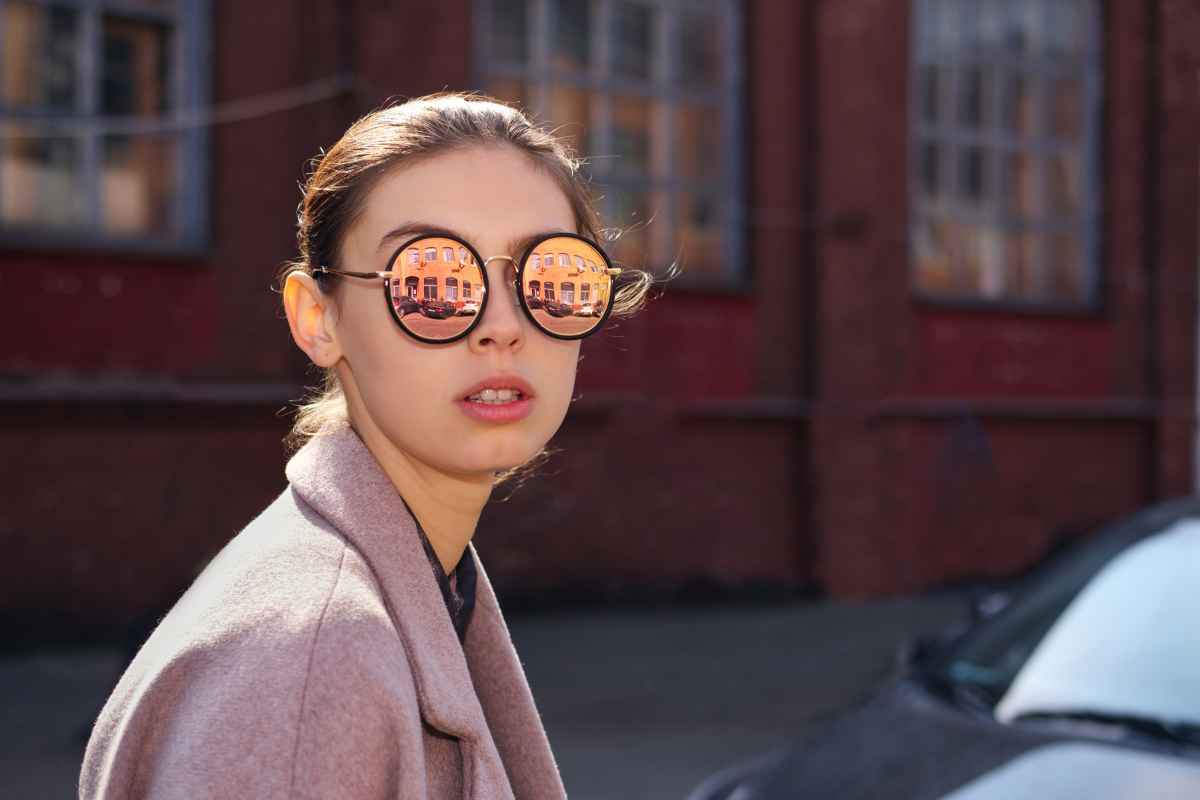 woman wearing a pair of modern vintage mirrored sunglasses
