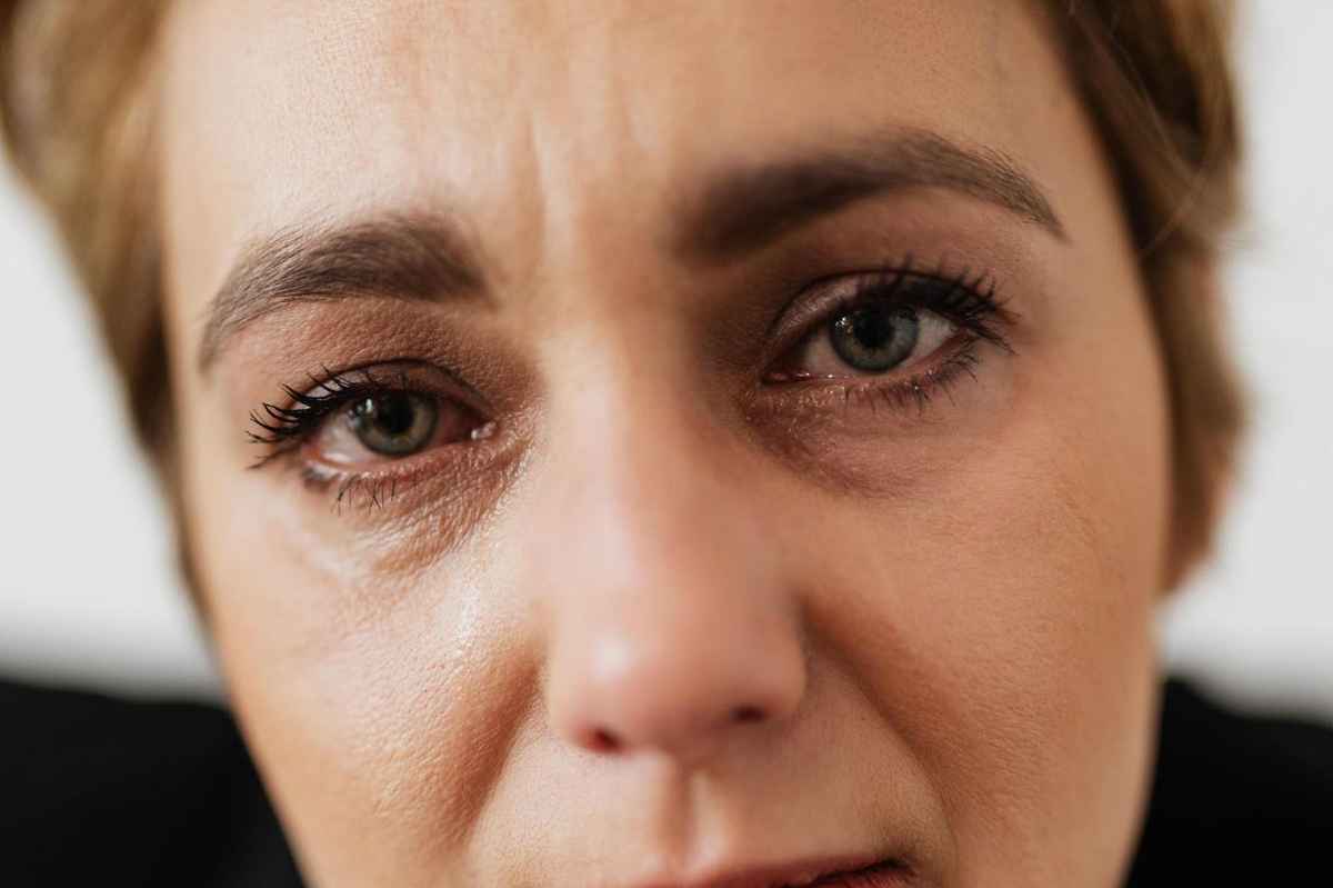 closeup of a woman face with teary eyes