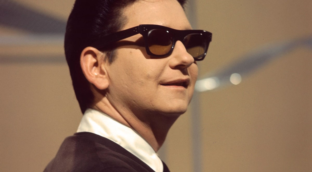 roy orbison wearing a pair of black square glasses