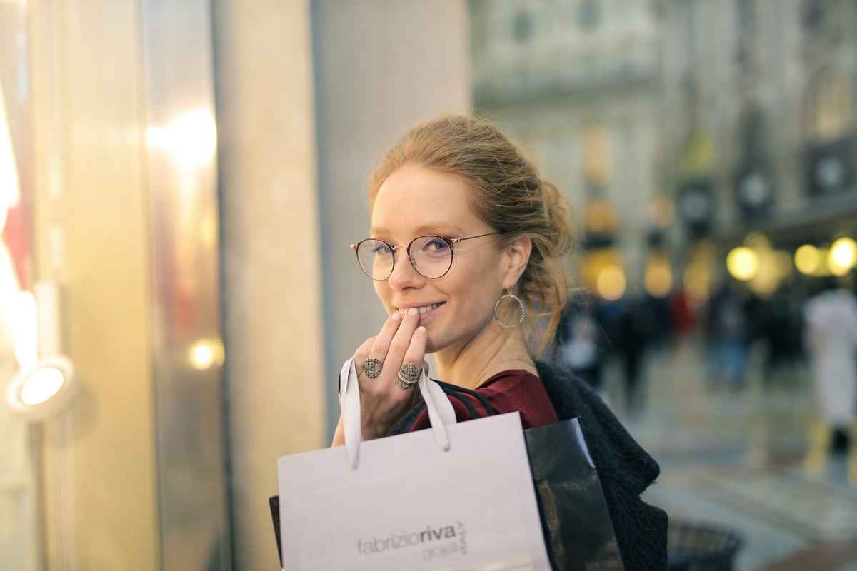 a smiling woman wearing pair of thin glasses frame