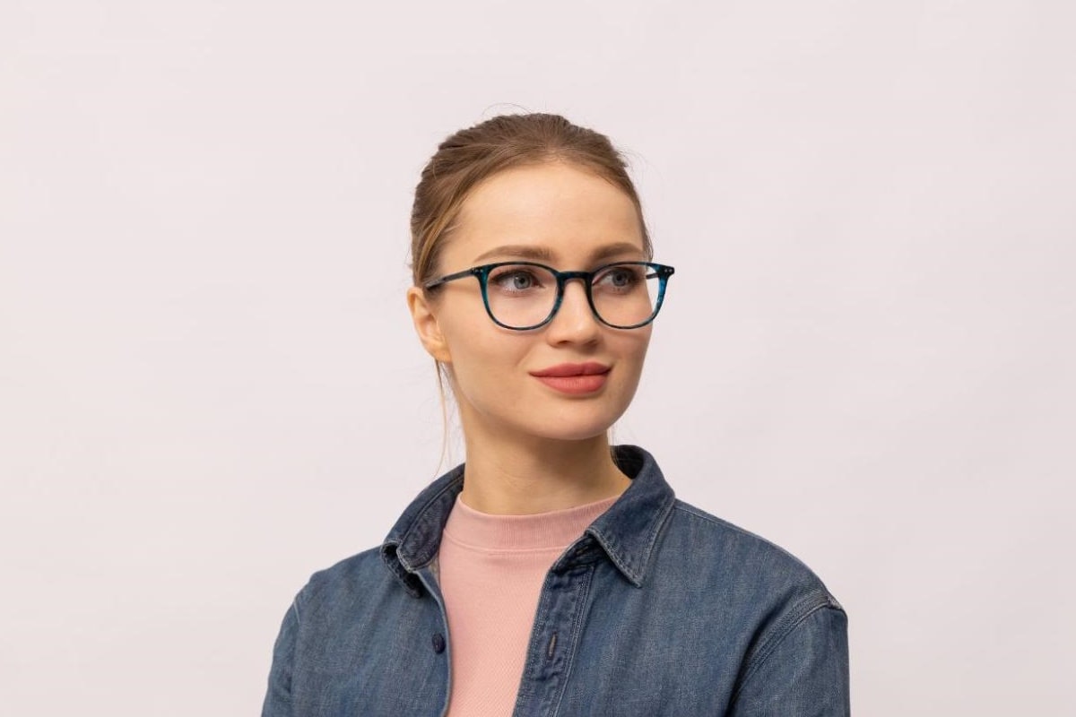 woman wearing a pair of full rim glasses exuding a cool serious vibe