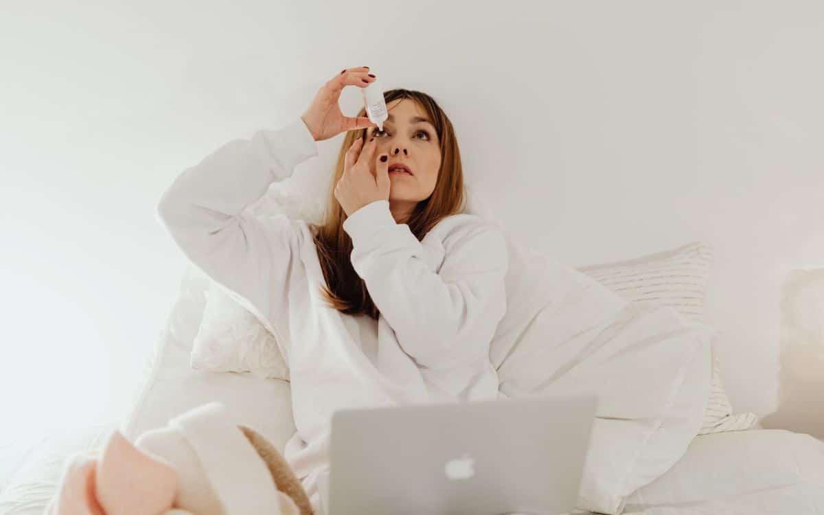 woman applying eye drop to avoid rubbing eyes