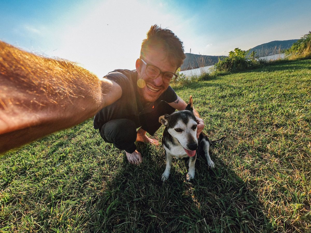 man wearing glasses and taking selfie in natural lighting