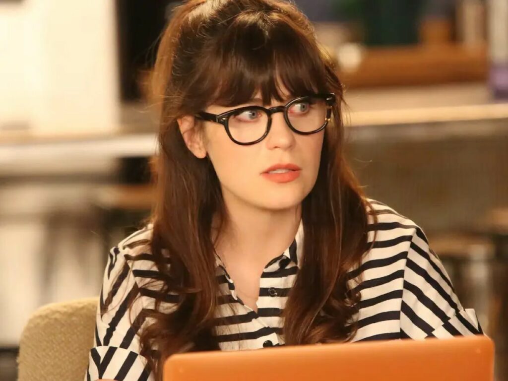 Zooey Deschanel wearing oversized tortoiseshell glasses as jess day in new girl