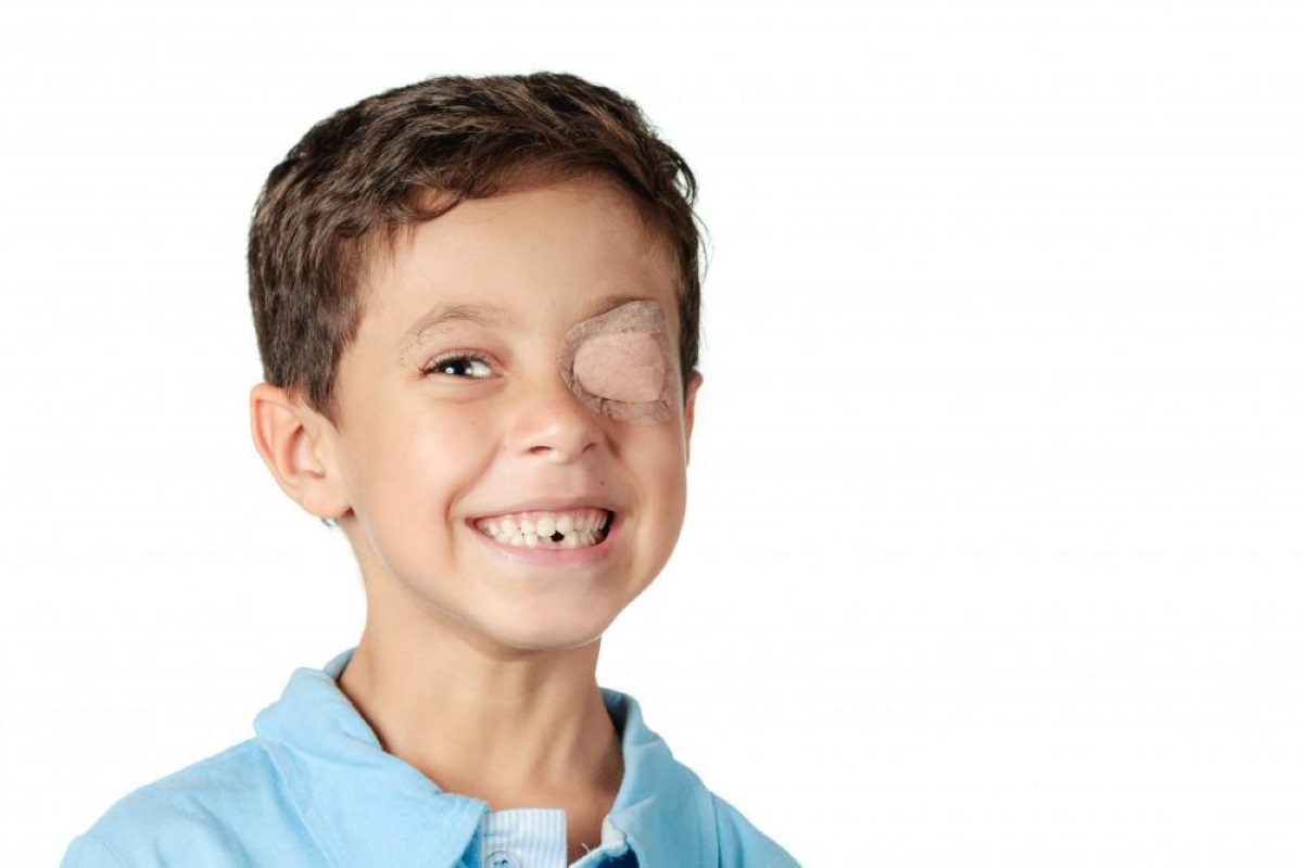 kid wearing an adhesive eyepatch